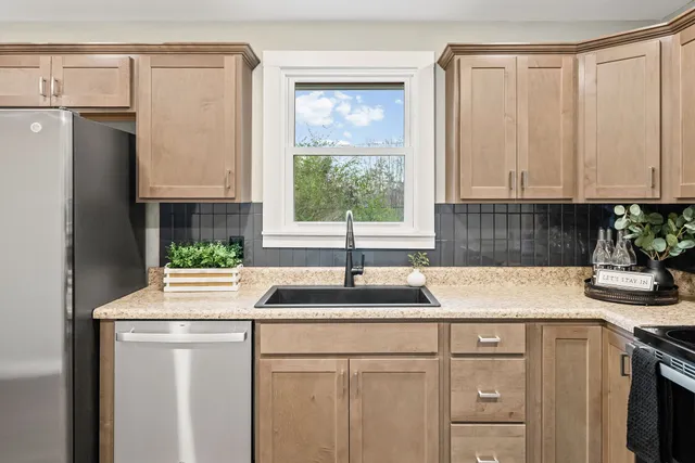 a kitchen with a sink stove and cabinets