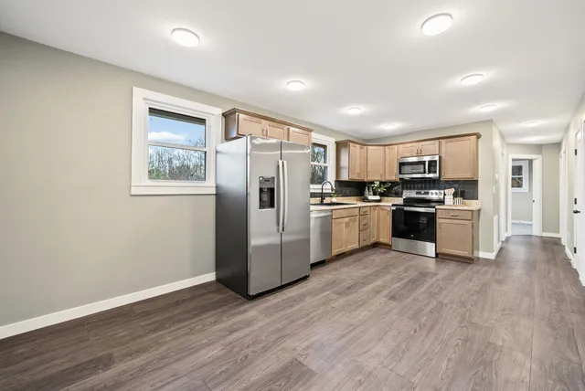 an empty room with a window and a fan