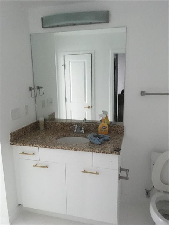 3324 Peachtree Road, Unit 2213 Atlanta, GA 30326 - Photo 14 of 42 a bathroom with a granite countertop sink and a toilet