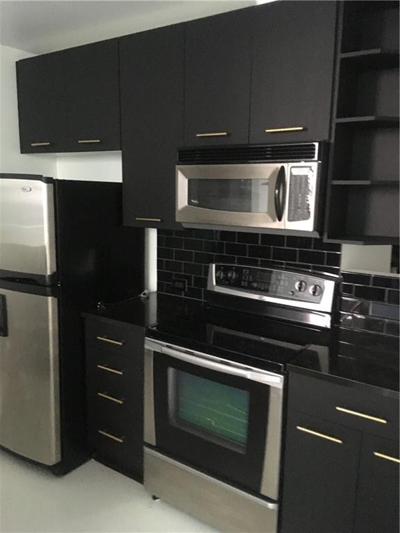 3324 Peachtree Road, Unit 2213 Atlanta, GA 30326 - Photo 16 of 42 a kitchen with microwave and cabinets