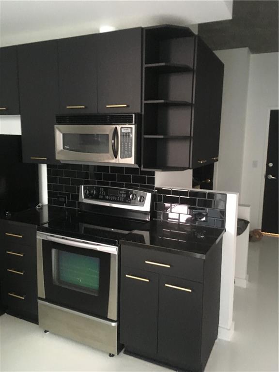 3324 Peachtree Road, Unit 2213 Atlanta, GA 30326 - Photo 17 of 42 a stove top oven sitting inside of a kitchen
