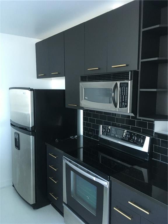 3324 Peachtree Road, Unit 2213 Atlanta, GA 30326 - Photo 20 of 42 a kitchen with granite countertop a stove and a refrigerator