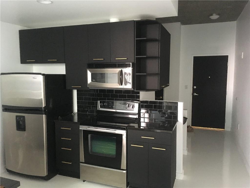 3324 Peachtree Road, Unit 2213 Atlanta, GA 30326 - Photo 2 of 42 a kitchen with granite countertop a refrigerator and a stove top oven