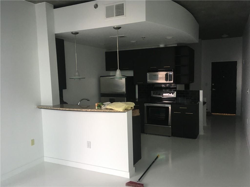 3324 Peachtree Road, Unit 2213 Atlanta, GA 30326 - Photo 3 of 42 a kitchen with a stove and a refrigerator