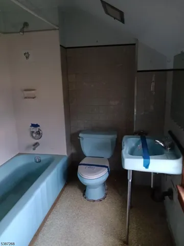 a bathroom with a sink toilet and a tub