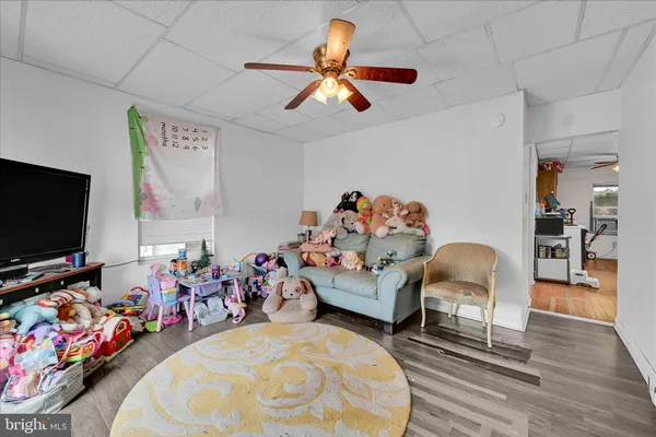a bedroom with furniture and a flat screen tv