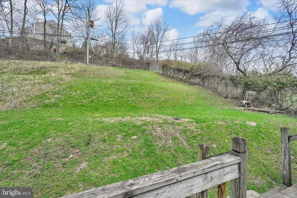 a view of a backyard with table and chairs with wooden fence