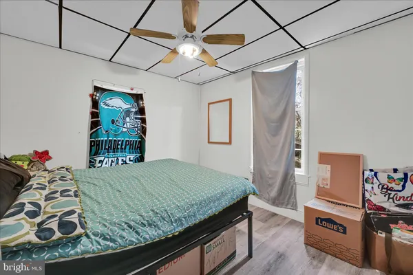 a bedroom with a bed and a dresser in it