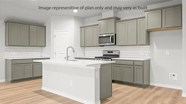 a kitchen with stainless steel appliances granite countertop a sink stove and microwave