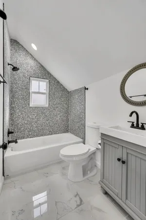 a bathroom with a toilet a sink and bathtub