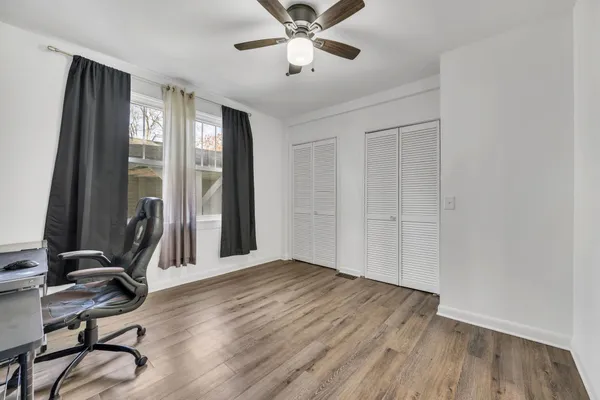 a view of a workspace with wooden floor