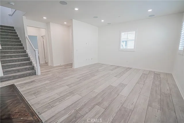 a living room with a bed furniture and a window