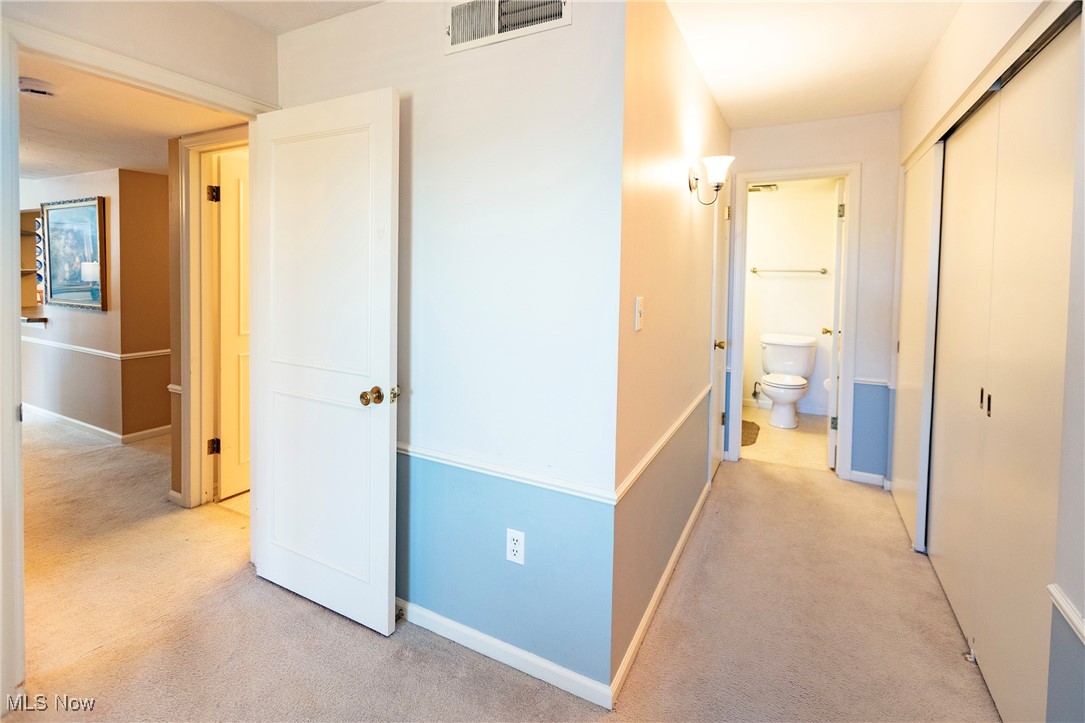 22701 Center Ridge Road, Unit 307 Rocky River, OH 44116 - Photo 20 of 27 Hallway featuring light colored carpet and baseboards