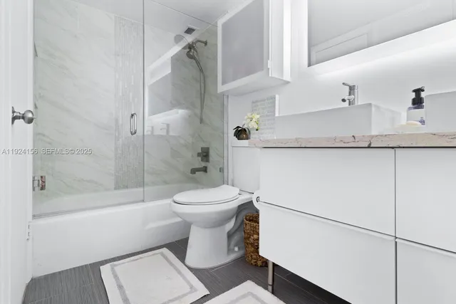 a bathroom with a toilet a sink and a shower
