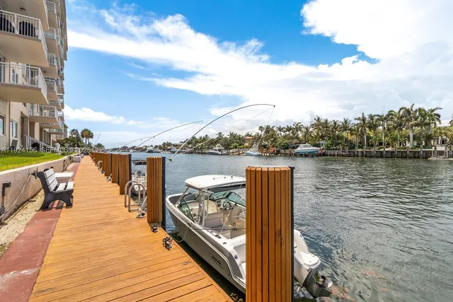 a view of a lake with boats in front of house