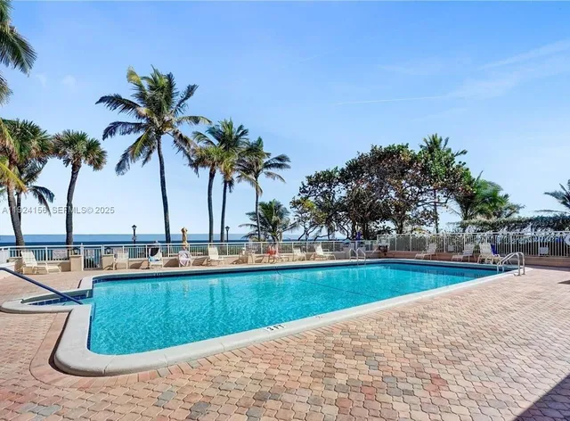 a view of a swimming pool and a yard