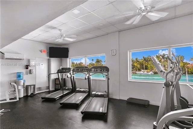 a room with gym equipment and large window