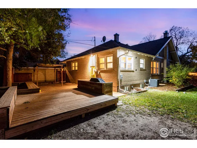 a park view with a bench and wooden fence