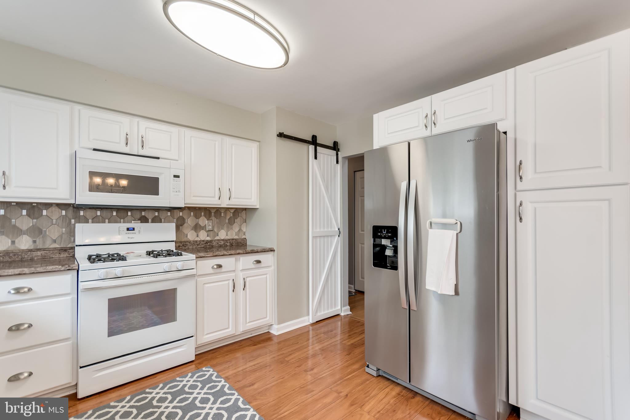 107 Capella Road Sewell, NJ 08080 - Photo 13 of 22 a kitchen with white cabinets white stainless steel appliances and refrigerator