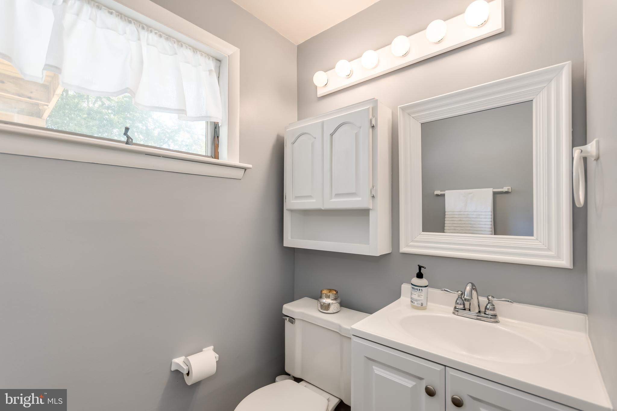 107 Capella Road Sewell, NJ 08080 - Photo 17 of 22 a bathroom with a toilet sink vanity and mirror