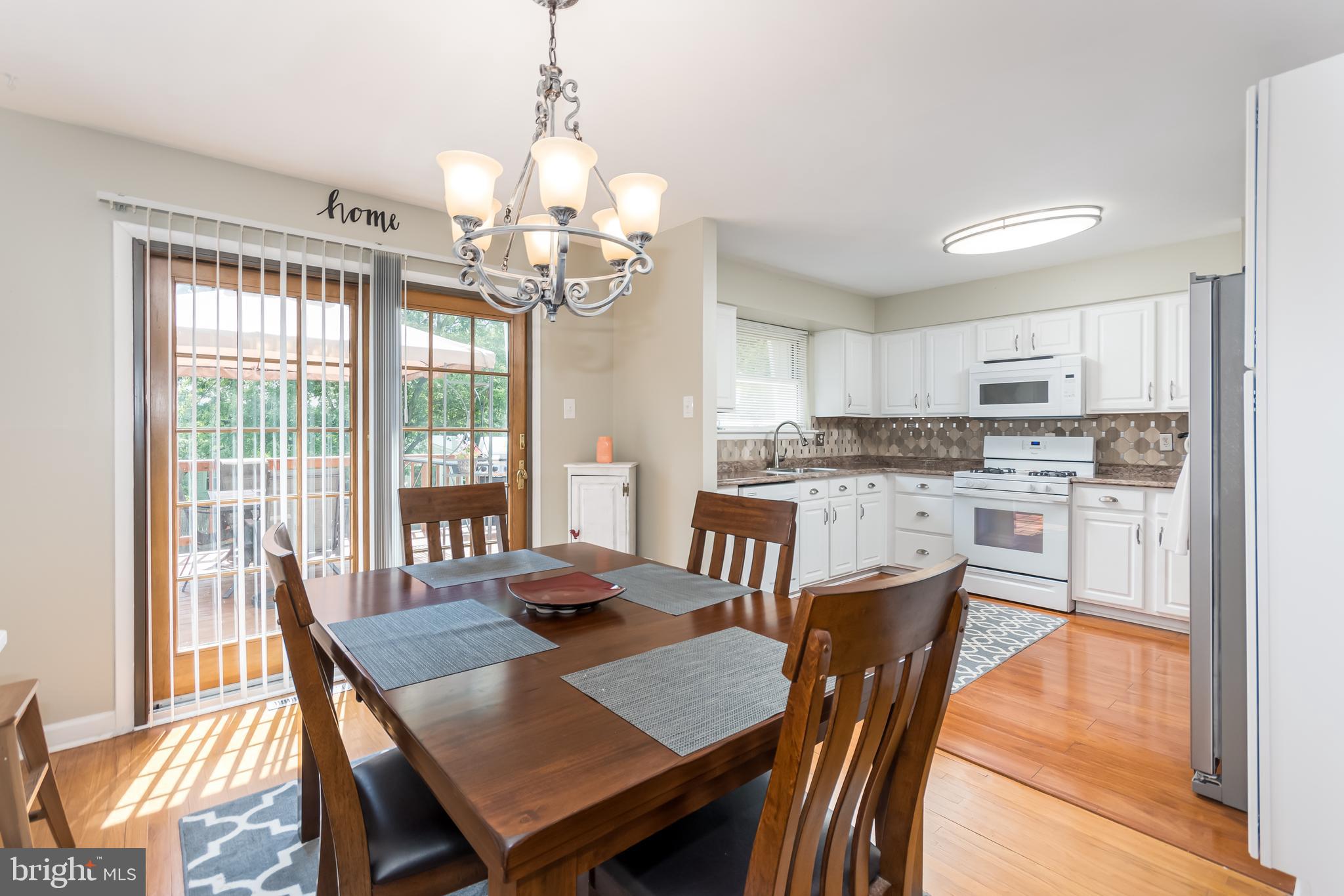 107 Capella Road Sewell, NJ 08080 - Photo 5 of 22 a view of a dining room with furniture a chandelier and wooden floor