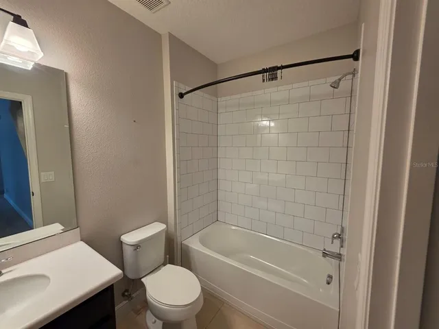 a bathroom with a shower a toilet and a sink