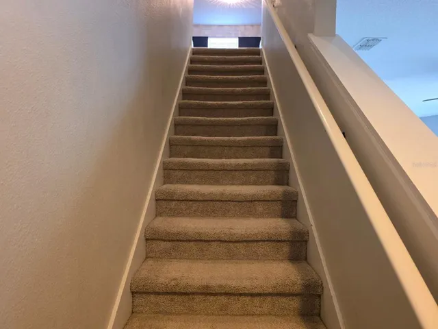 a view of an empty room with a fireplace and cabinet