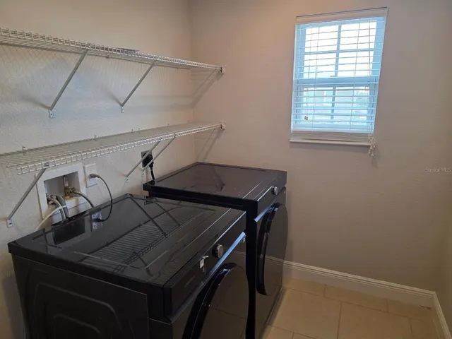 a view of a hallway with a small space and a chandelier