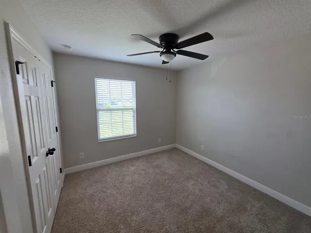 a view of a big room with a ceiling fan