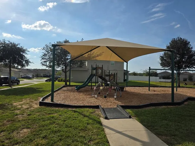 a view of a house with swimming pool and sitting area