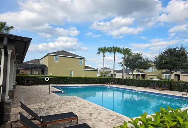 a view of a swimming pool with a yard