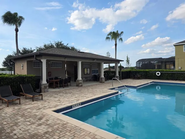 a view of a house with pool porch and a yard