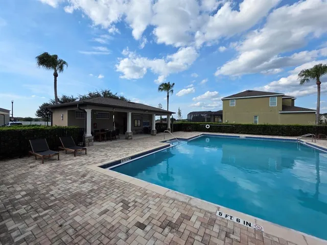 a view of a swimming pool with a patio