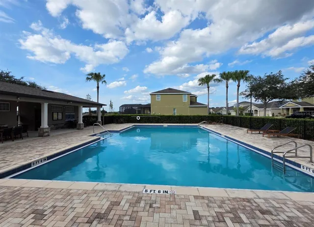 a view of a swimming pool with a table and chairs