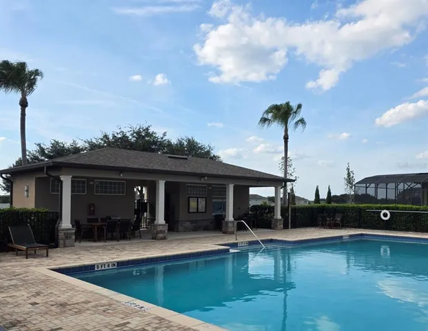 a view of a swimming pool with lounge chairs