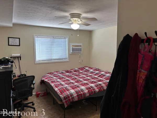 a bedroom with a bed and dresser with mirror