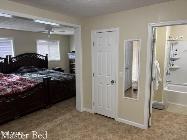 a bedroom with a bed and a large mirror