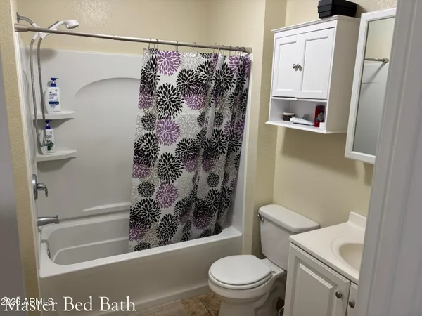 a bathroom with a shower a toilet and a shower