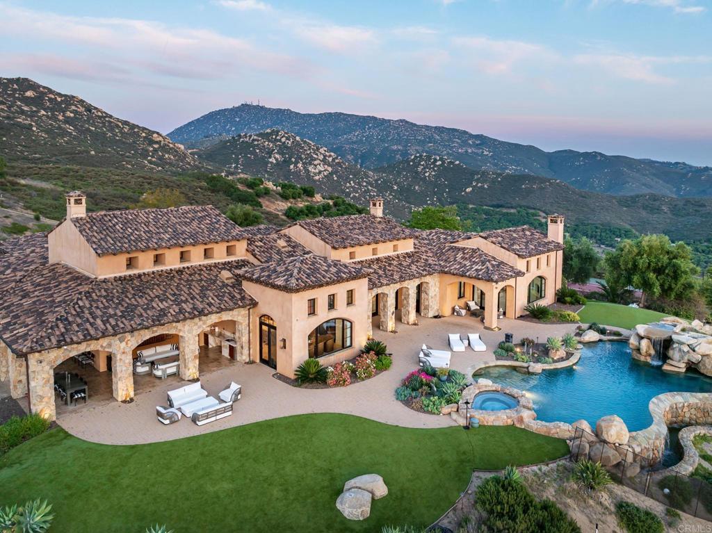 an aerial view of a house with outdoor space and lake view