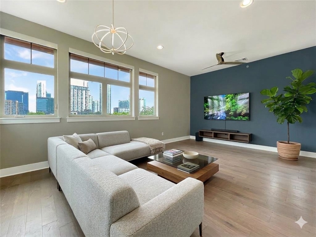 908 Nueces Street, Unit 42 Austin, TX 78701 - Photo 1 of 21 a living room with furniture and a flat screen tv