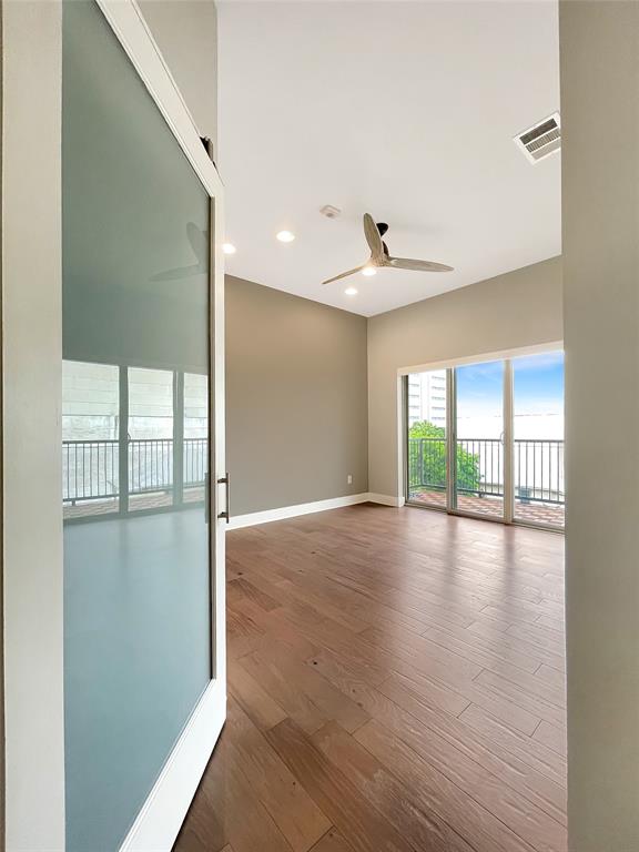 908 Nueces Street, Unit 42 Austin, TX 78701 - Photo 11 of 21 a view of empty room with wooden floor and fan