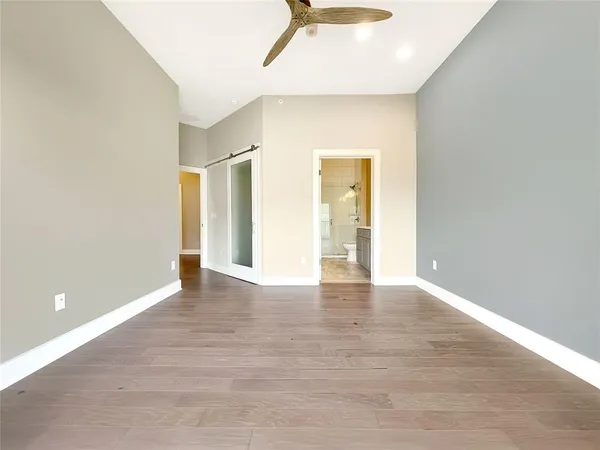 a view of an empty room with wooden floor