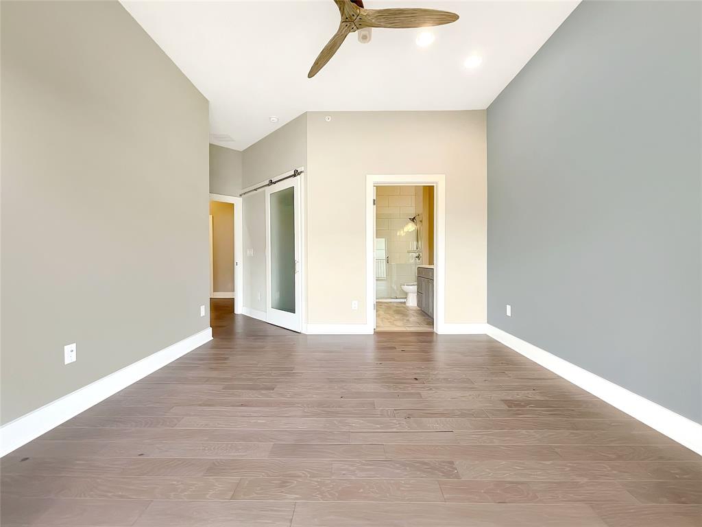 908 Nueces Street, Unit 42 Austin, TX 78701 - Photo 12 of 21 a view of an empty room with wooden floor