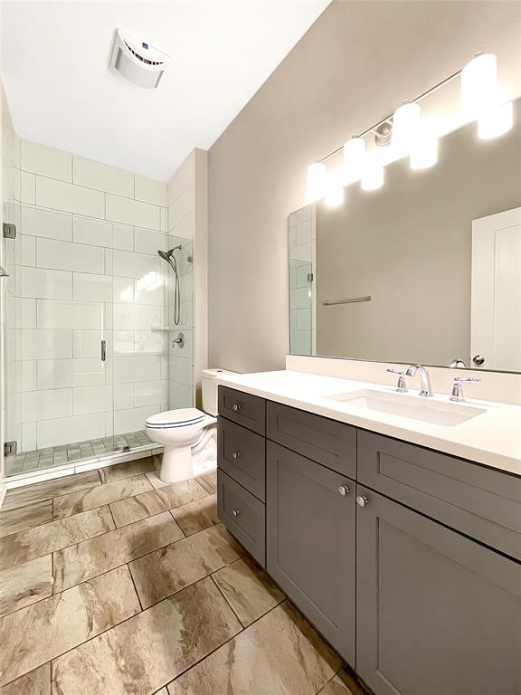 908 Nueces Street, Unit 42 Austin, TX 78701 - Photo 14 of 21 a spacious bathroom with a bathtub shower sink mirror and toilet