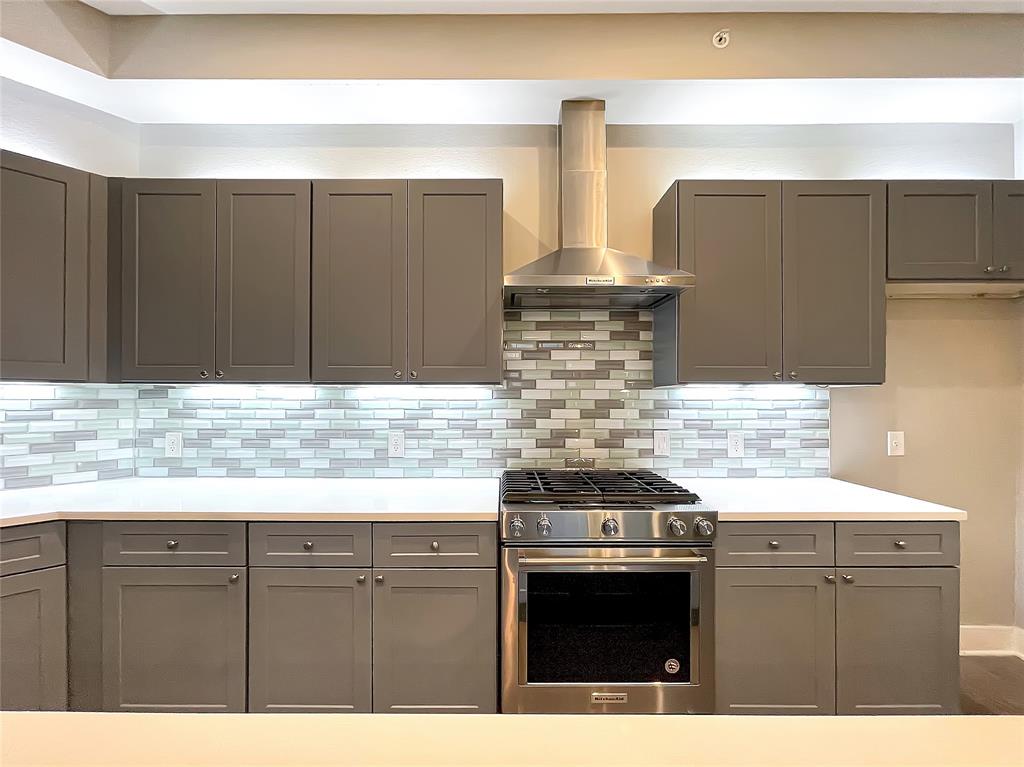 908 Nueces Street, Unit 42 Austin, TX 78701 - Photo 9 of 21 a kitchen with stainless steel appliances granite countertop a stove and a sink