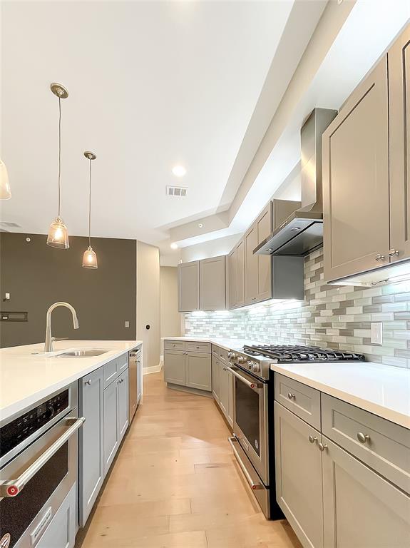 908 Nueces Street, Unit 42 Austin, TX 78701 - Photo 10 of 21 a kitchen with a sink stove and cabinets