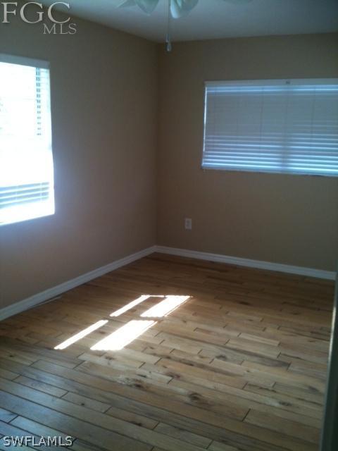 5524 Seville Road Fort Myers, FL 33919 - Photo 5 of 6 a view of empty room with wooden floor and fan