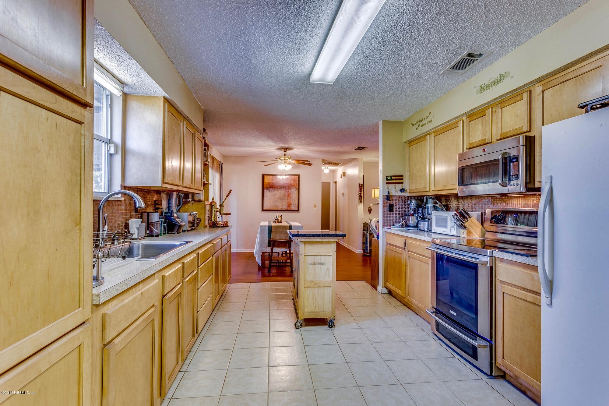 1670 Borrow Pit Road St. Johns, FL 32259 - Photo 12 of 35 a kitchen with stainless steel appliances granite countertop a refrigerator and a stove