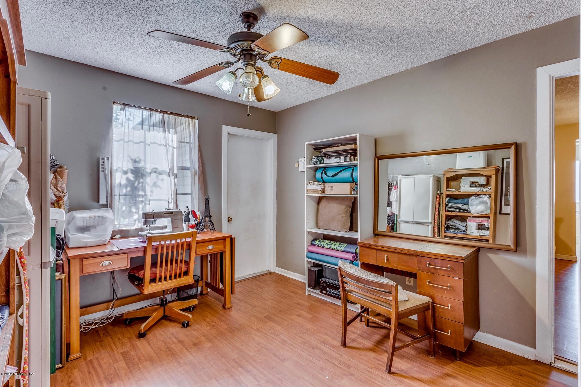 1670 Borrow Pit Road St. Johns, FL 32259 - Photo 14 of 35 a view of a workspace with furniture and a window