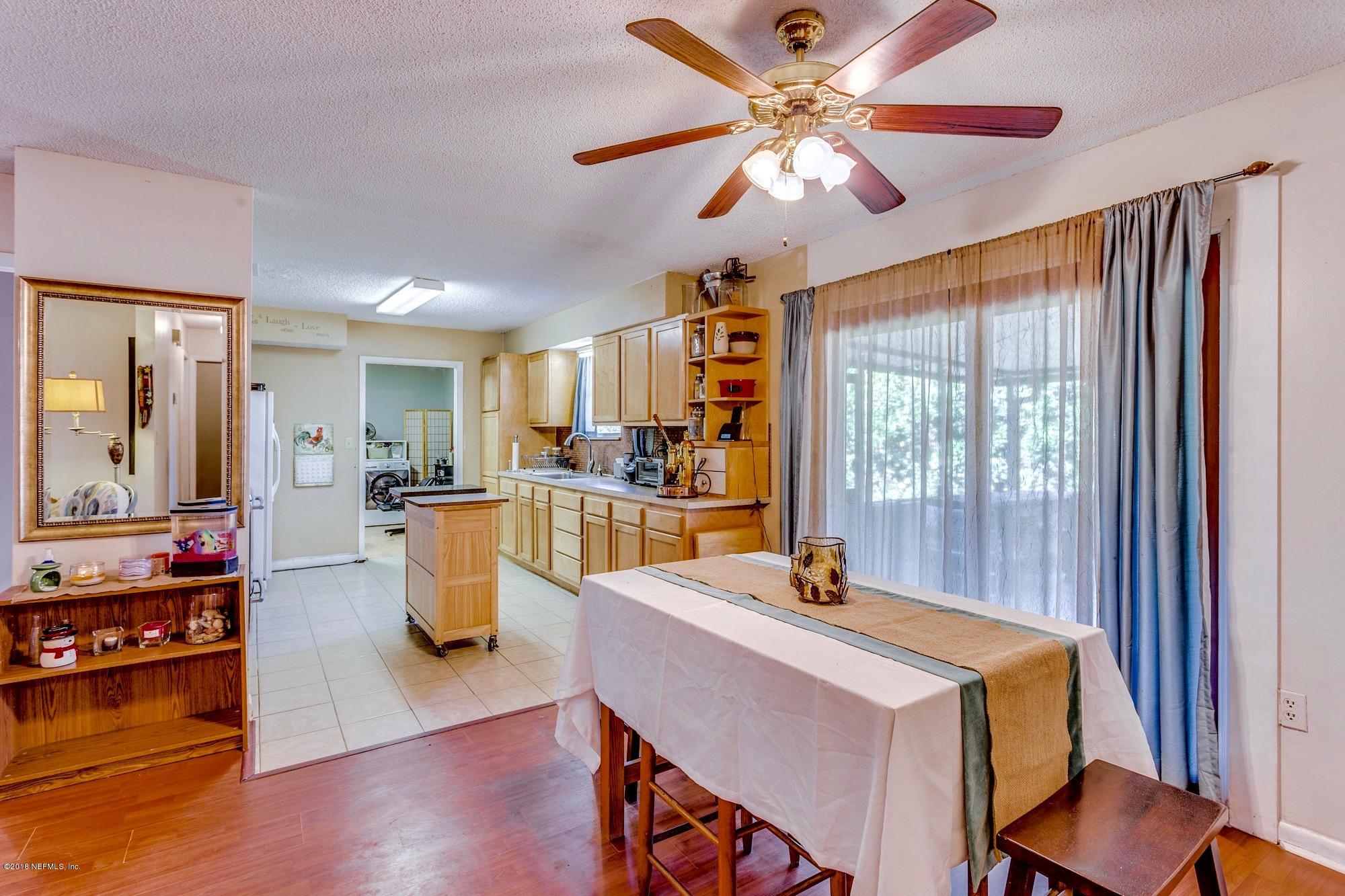 1670 Borrow Pit Road St. Johns, FL 32259 - Photo 8 of 35 a living room with dining room and wooden floor